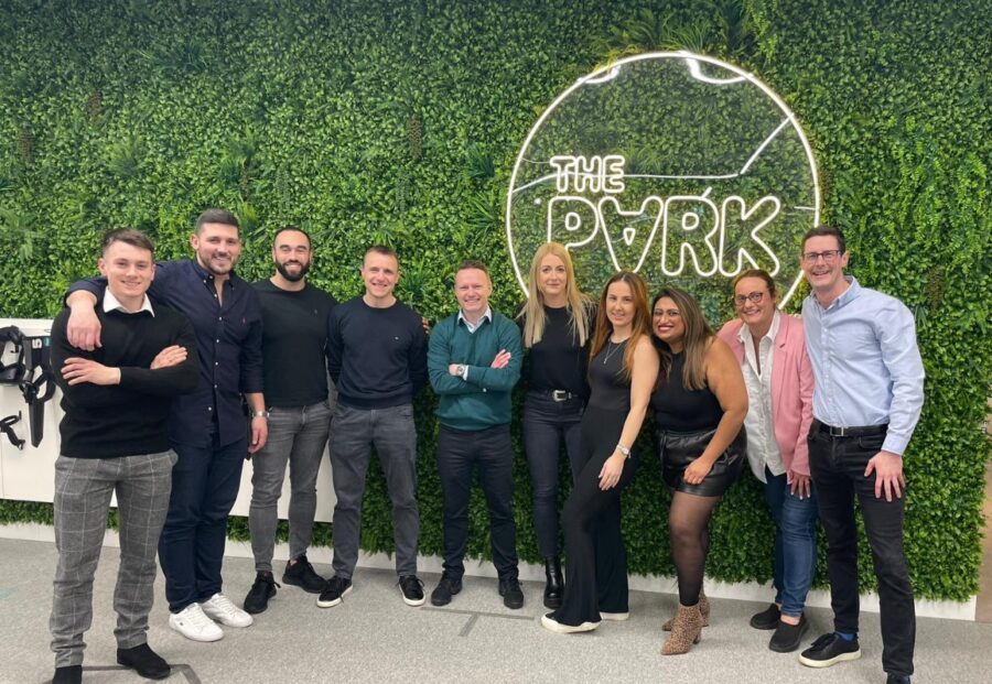 A photo of Craig and his team of GRG Executive Search colleagues. They are all stood together in a row smiling, whilst at a team bonding event.